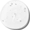 A close-up, top-down view of a clear liquid with small bubbles and particles suspended within it, presented in a circular shape against a white background. Podgląd zdjęcia produktu