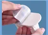 Hands peeling off the backing of a 3M adhesive sticker from a white product. Náhled obrázku produktu