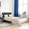 A bedroom scene with a bed, blue curtains, and a window. Náhled obrázku produktu