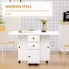 A white folding dining table with drawers and cabinets, set in a kitchen with a tiled backsplash. Produktbild-Vorschau