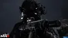 A soldier in tactical gear with night vision goggles holding a rifle in a dark, atmospheric setting. Produktbild-Vorschau