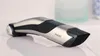 A close-up, studio shot of a Philips body groomer on a reflective surface. Podgląd zdjęcia produktu