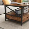 A close-up view of a rustic-style coffee table with a drawer, placed on a rug next to a sofa. Náhľad obrázku produktu