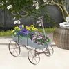 A wooden wagon filled with flowers sits on a patio next to a woven table. Voir les images du produit