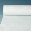 A roll of white damask tablecloth is shown on a light blue background. Podgląd zdjęcia produktu