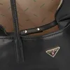 A close-up view of the interior and exterior details of a black Guess shopper bag. Produktbild-Vorschau