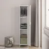 A tall, narrow white metal wardrobe with its door open, revealing clothes and storage boxes inside. A wire basket with blankets is next to it. Produktbild-Vorschau