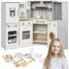 A child is in the foreground with a toy kitchen set behind her. Produktbild-Vorschau
