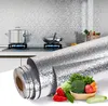 A kitchen scene with a roll of foil wallpaper in the foreground, and vegetables in a basket. Produktbild-Vorschau