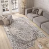 A living room scene with a rug, sofa, and ottoman. Voir les images du produit