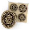 A set of four round coasters with mandala designs, packaged together. Produktbild-Vorschau