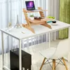 A white desk with a bamboo laptop stand, a laptop, a plant, a book, and a coffee cup. Produktbild-Vorschau