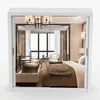 A bedroom viewed through a mirrored closet door. Produktbild-Vorschau