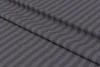 A close-up, angled view of a folded piece of fabric with a striped pattern. Produktbild-Vorschau