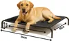 A yellow Labrador dog lying on a black elevated dog bed. Dimensions are indicated with arrows and text. Náhled obrázku produktu