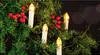 Close-up of LED candle lights and red berries on a Christmas tree. Náhled obrázku produktu