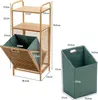 A bamboo shelving unit with a folding laundry basket, next to a separate green laundry basket. Dimensions are shown with text overlays. Produktbild-Vorschau