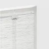 A close-up view of the top mechanism and upper portion of a white bamboo roller blind. Náhled obrázku produktu
