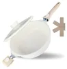 A white speckled frying pan with a glass lid and a wooden handle, shown at an angle on a white background. A beige trivet with the word 'divory' is visible to the right. Produktbild-Vorschau