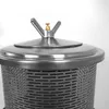 Close-up view of the top of a stainless steel press with a perforated cylinder and a domed lid. Produktbild-Vorschau