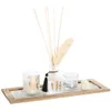 A decorative set of home fragrance items including a reed diffuser, a candle, and a small glass holder, arranged on a wooden tray filled with small white stones. Produktbild-Vorschau