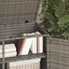 A close-up view of a grey poly rattan garden cabinet with shelves holding books and a basket. Náhled obrázku produktu