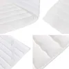 A collage of close-up shots of a white quilted mattress or topper, showing different textures and stitching details. Náhled obrázku produktu
