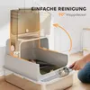 A person is cleaning a cat litter box with a scoop, highlighting its easy cleaning feature. Produktbild-Vorschau