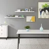 A modern living room with shelves, a table, and artwork. Produktbild-Vorschau