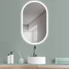 A modern bathroom vanity with a sink, faucet, and an oval LED mirror.