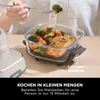 A person is using a Ninja CRISPi air fryer to cook salmon and vegetables in a glass container. Anteprima dell’immagine prodotto