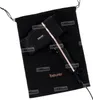 A black hairdryer with rose gold accents is placed inside a black drawstring bag, with the bag partially open. Podgląd zdjęcia produktu