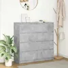 A gray sideboard with eight drawers is shown in a room with a plant and a coat rack. Náhled obrázku produktu