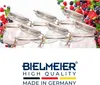 Several glass jars with silver and gold clasps are arranged in rows, with a scattering of berries in the background. Below the jars is a logo and text. Produktbild-Vorschau