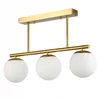 A three-light ceiling fixture with gold-toned metal accents and white glass globes, presented against a white background. Náhľad obrázku produktu