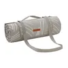 A rolled-up picnic blanket with straps and a brand tag. Produktbild-Vorschau