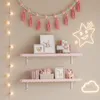 A child's bedroom wall decorated with shelves, garlands, and neon lights. Anteprima dell’immagine prodotto