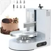A cake decorating machine with a cake and accessories. Náhľad obrázku produktu