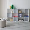 A white modular bookshelf filled with decorative items and books, positioned against a white wall. Anteprima dell’immagine prodotto