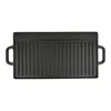 A black cast iron grill plate with raised ridges and handles on a white background. Produktbild-Vorschau