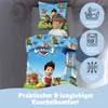 A child is lying on a bed with Paw Patrol bedding. The bedding features characters from the Paw Patrol show. There are also icons indicating washing instructions. Produktbild-Vorschau
