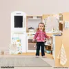 A young child stands in front of a wooden play kitchen, which is equipped with various accessories. Podgląd zdjęcia produktu