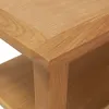 A close-up view of the corner of a wooden coffee table, showing the grain and construction. Náhled obrázku produktu
