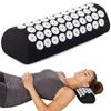 A woman is lying down with her head resting on an acupressure pillow. Podgląd zdjęcia produktu