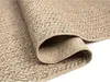 A close-up view of a rolled-up rug, showing its texture and weave. Náhled obrázku produktu
