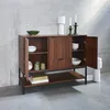 A wooden sideboard with open doors and shelves, displaying various decorative items and bowls, set against a concrete wall. Produktbild-Vorschau