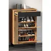 A wooden shoe cabinet with multiple shelves and a drawer, filled with shoes. Produktbild-Vorschau