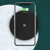 A smartphone is placed on a black wireless charging pad, with a marble-like pattern and a dark green background. Produktbild-Vorschau