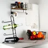 A kitchen counter with a wine rack, fruit basket, and paper towel holder. Anteprima dell’immagine prodotto