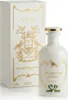 A white bottle of Gucci perfume with gold accents and a matching box. Anteprima dell’immagine prodotto
